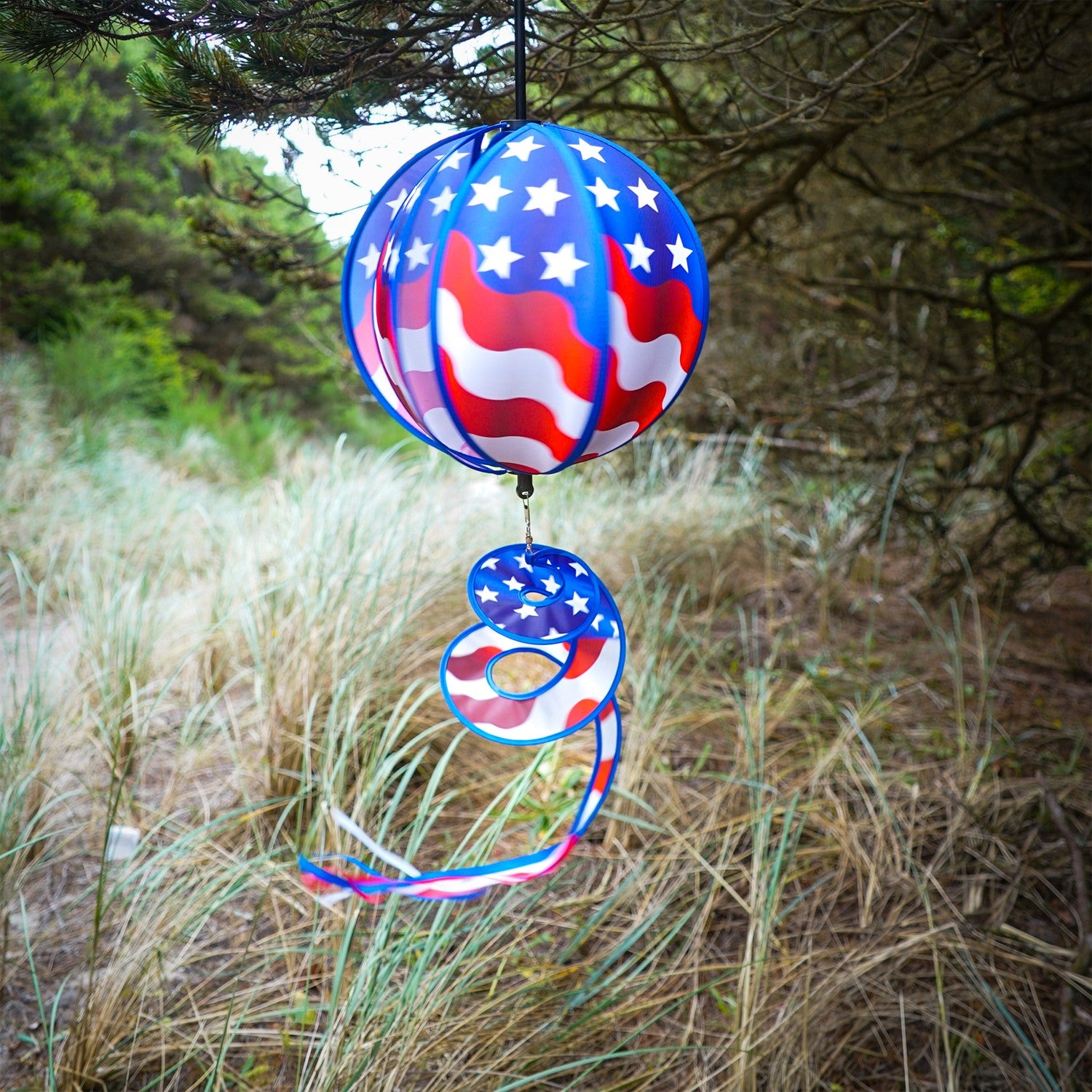 This 11" USA Flag Hanging Ball Spinner features six vibrant flag panels that spin in the wind, creating a beautiful display for any patriotic occasion.