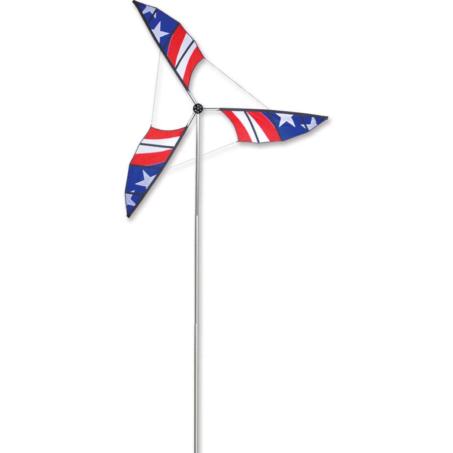 12.5 ft. Wind Generator with colorful blades spinning elegantly atop a sturdy aluminum mast, set against a bright blue sky in an outdoor garden.