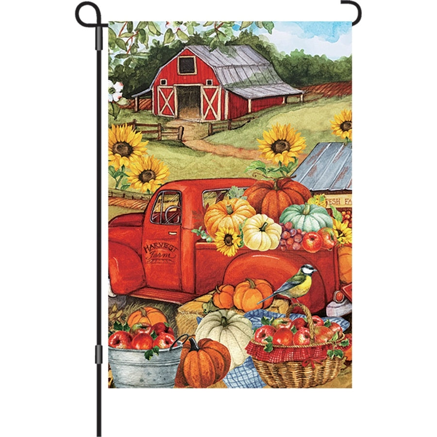 12 in. Autumn Truck Flag featuring a nostalgic truck surrounded by pumpkins and colorful leaves, designed for outdoor garden display.