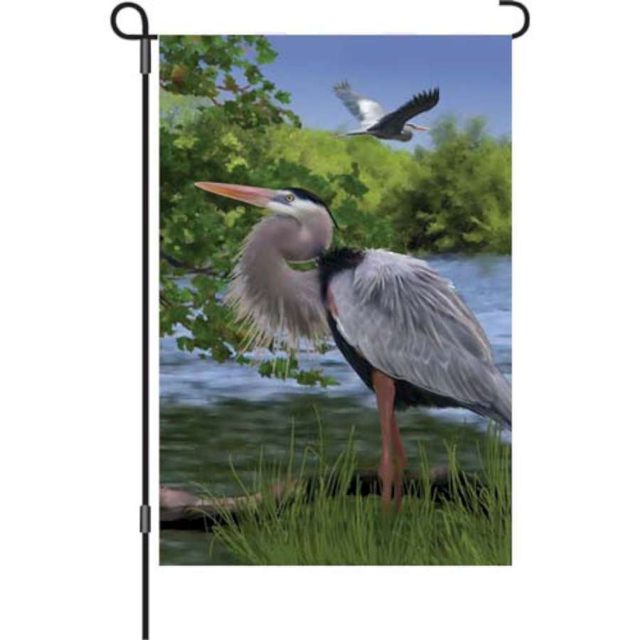 12 in. Blue Heron Bay flag featuring a blue heron in a vibrant garden setting, designed for outdoor decoration and nature appreciation.