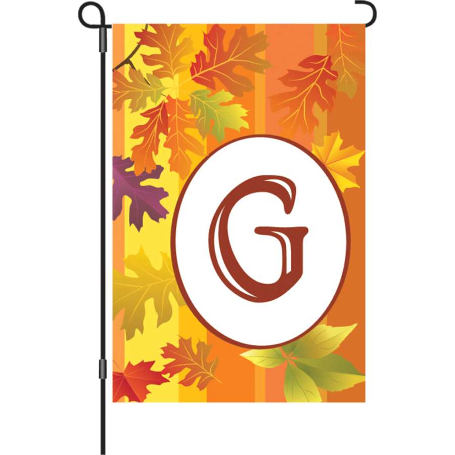 12 in. Fall Monogram Flag - G featuring vibrant autumn colors displayed in a garden setting with a clear focus on the personalized design.