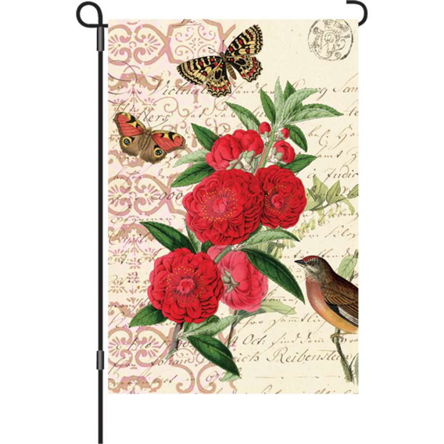 12 in. Antique Apricot garden flag illuminated with vibrant colors, displaying a floral design in an outdoor setting, enhancing the garden ambiance.