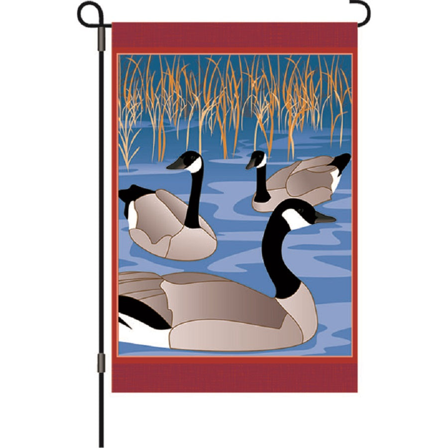 12 In Flag - Crisfield Visitors featuring colorful autumn designs displayed on a garden flag stand in a fall setting.