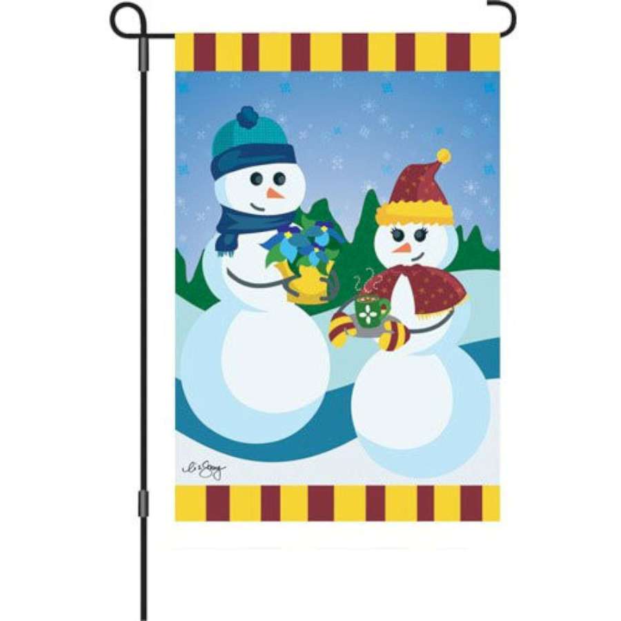 12 in. garden flag - Dating on a Snowy Slope, featuring a winter scene of a couple on a snowy hillside, displayed on a garden flag stand.