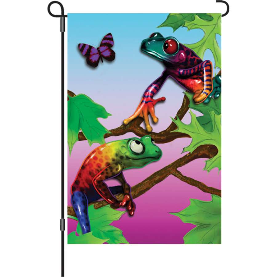 12 in. Frolicking Frogs garden flag featuring colorful, playful frogs displayed on a garden flag stand in a vibrant outdoor setting.