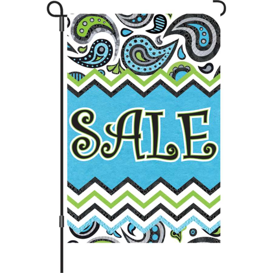 12 in. Flag - Paisley Sale displayed in a garden, showcasing a vibrant paisley design that reads 'SALE' on both sides.