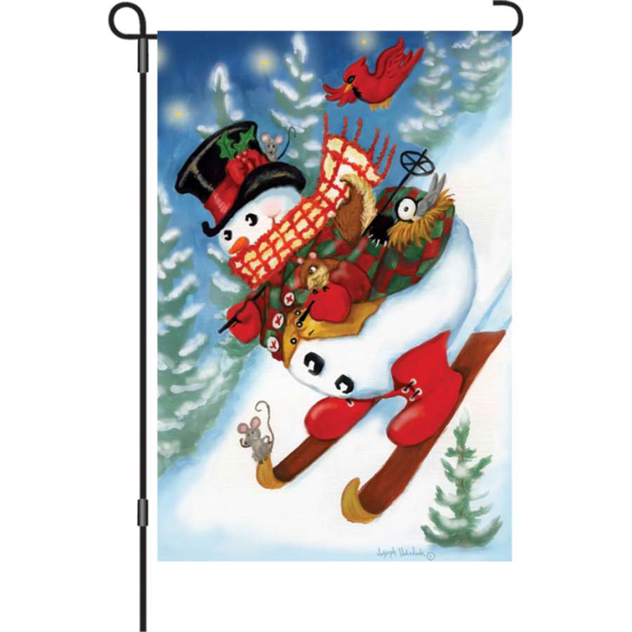 Illuminated 12 in. Ski Party garden flag featuring colorful ski gear and snowflakes, displayed in an outdoor setting during winter.