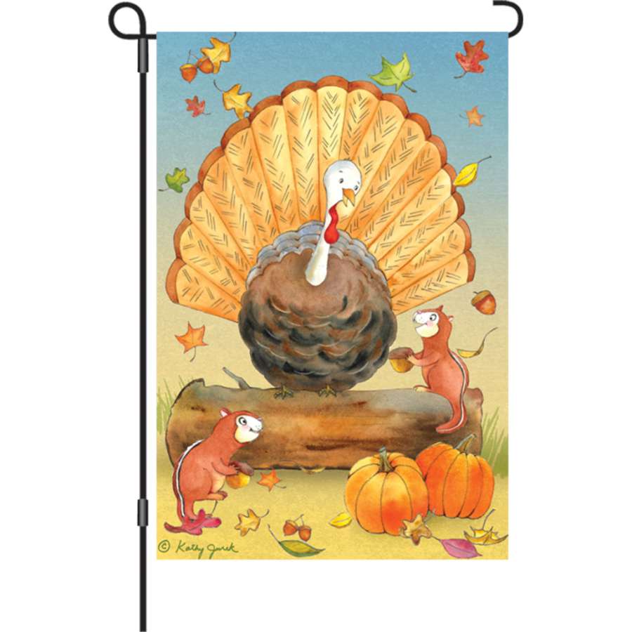 Illuminated 12 in. Flag - Turkey & Friends displayed in a garden, featuring colorful turkeys and seasonal designs for autumn celebrations.