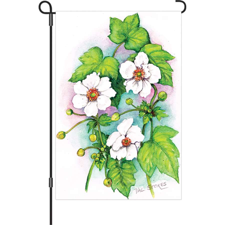 Illuminated 12 in. Floral Impressions garden flag featuring colorful floral designs displayed in a garden setting, enhancing outdoor decor.