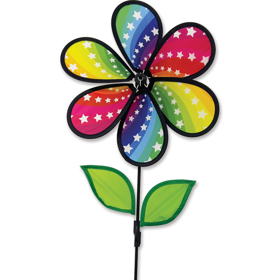 Vibrant 12 in. Flower Spinner - Rainbow Stars with colorful petals spinning in a garden setting, enhancing the outdoor atmosphere.
