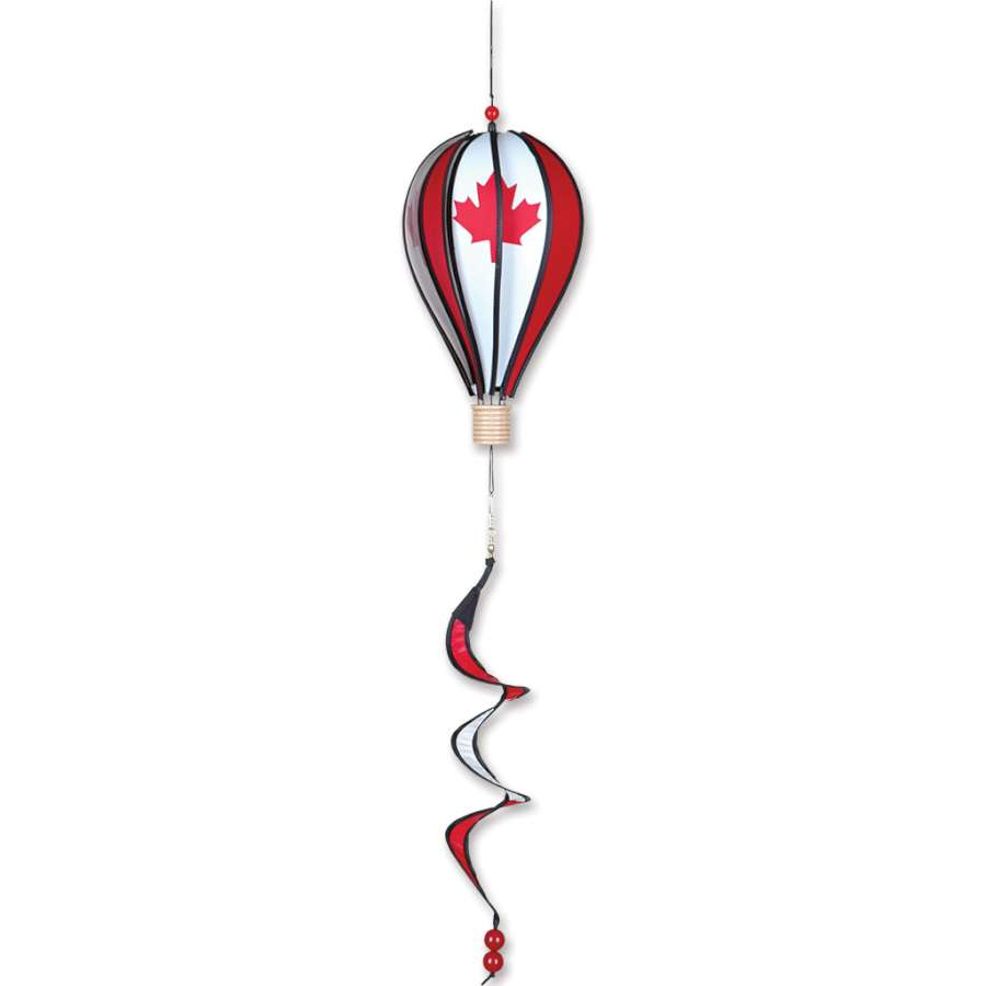 Colorful 12 in. Hot Air Balloon with Canadian design, featuring maple leaves, spinning gently in a garden setting.