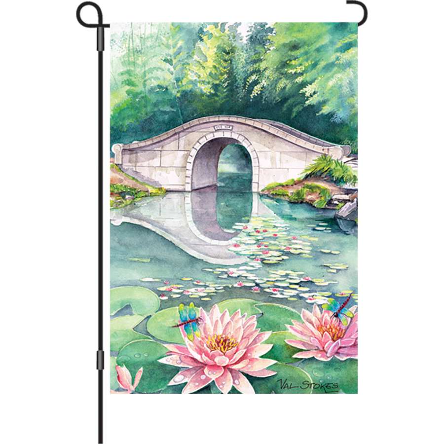 Illuminated 12 in. Waterlily Garden flag displayed outdoors, featuring a vibrant waterlily design on a durable polyester fabric.