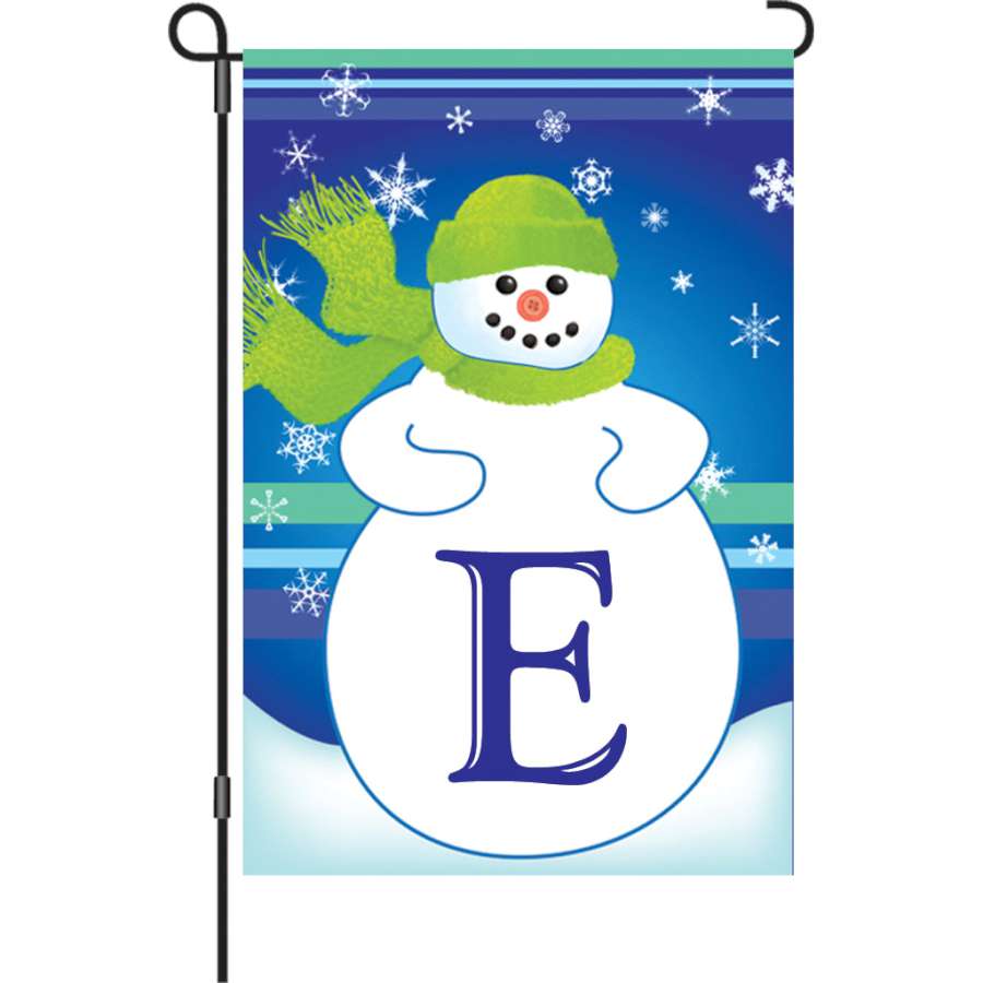 12 in. Winter Monogram Flag - E displayed outdoors, showcasing a colorful personalized monogram against a winter backdrop.