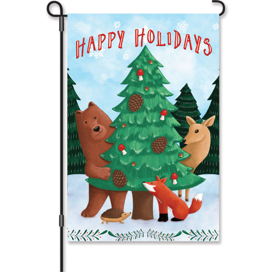 12 in. Woodland Christmas Flag with 'HAPPY HOLIDAYS' message and charming woodland imagery, displayed in a garden setting with winter decor.