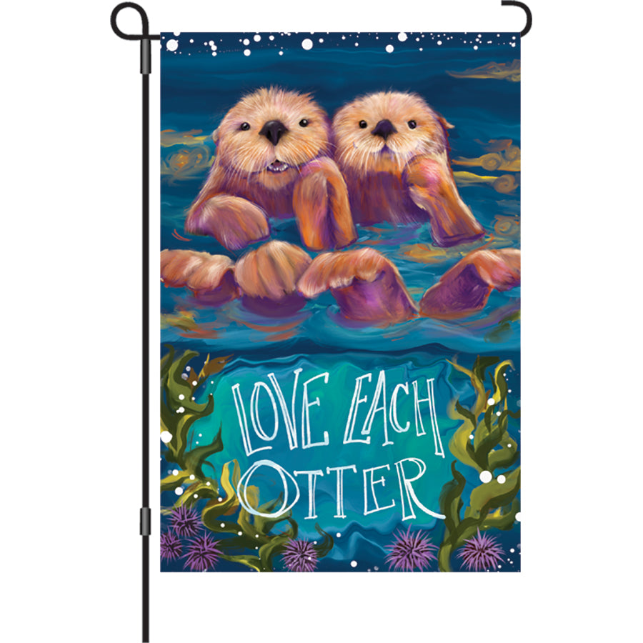 12-inch Sea Otters garden flag displaying two cute otters floating under stars, proudly showcasing the phrase 'Love Each Otter' in a vibrant garden setting.