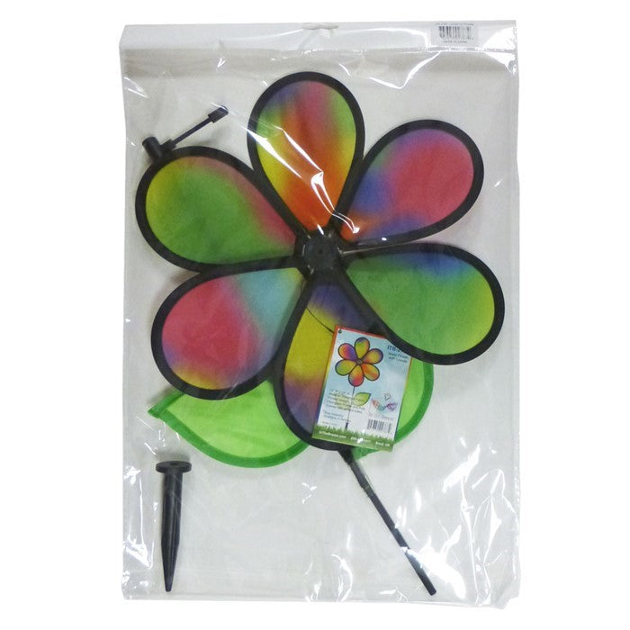 12-inch Jewel Flower spinner with colorful petals and leaves attached to a sturdy fiberglass pole, twirling beautifully in a garden setting.