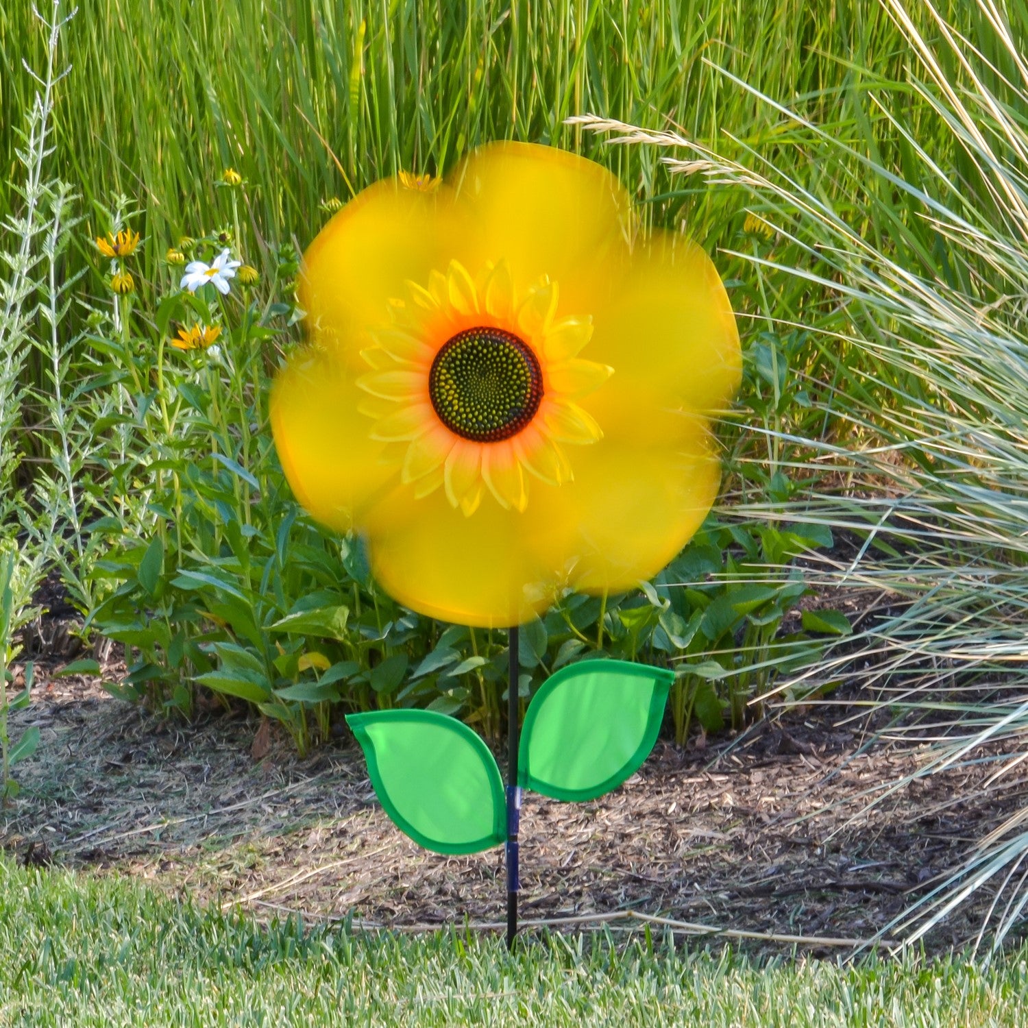 12" yellow sunflower spinner with bright petals and green leaves, designed to spin in the breeze for colorful outdoor decoration.