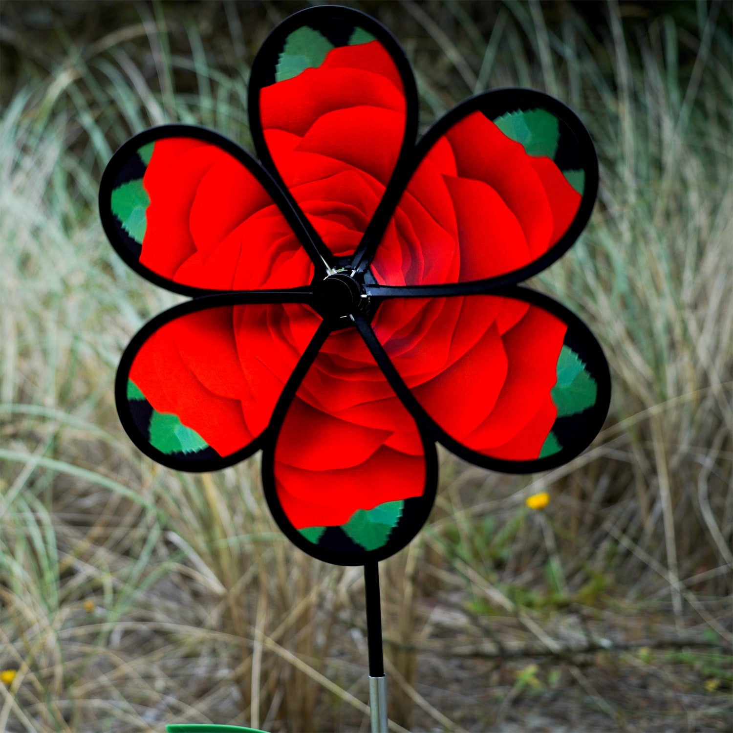 Beautiful 13.5 inch Rose Spinner with Leaves featuring realistic petals and green leaves, spinning in a garden setting on a fiberglass pole.
