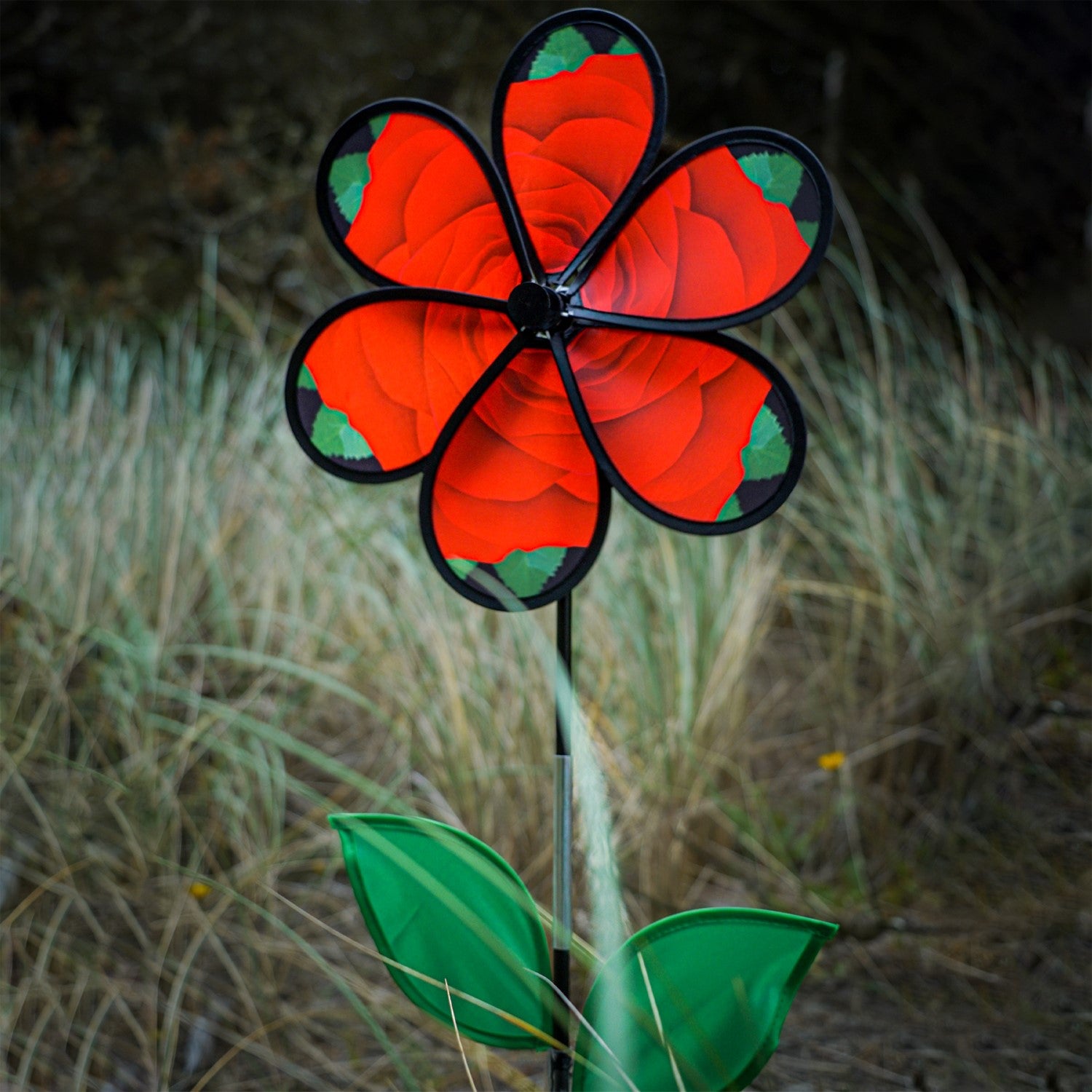 Beautiful 13.5 inch Rose Spinner with Leaves featuring realistic petals and green leaves, spinning in a garden setting on a fiberglass pole.
