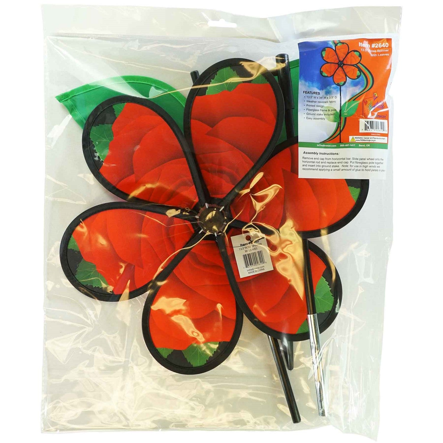 Beautiful 13.5 inch Rose Spinner with Leaves featuring realistic petals and green leaves, spinning in a garden setting on a fiberglass pole.