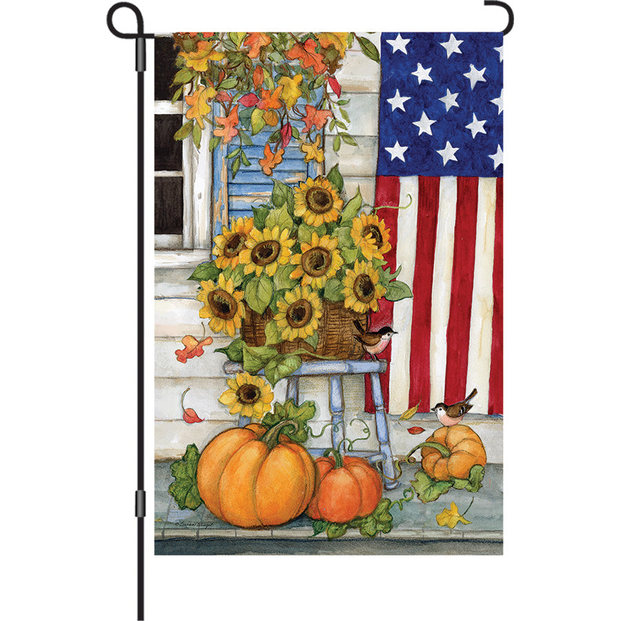 13 in. Elite Oversized Garden Flag featuring autumn-themed designs, displayed on a garden flag pole in a welcoming front porch setting.