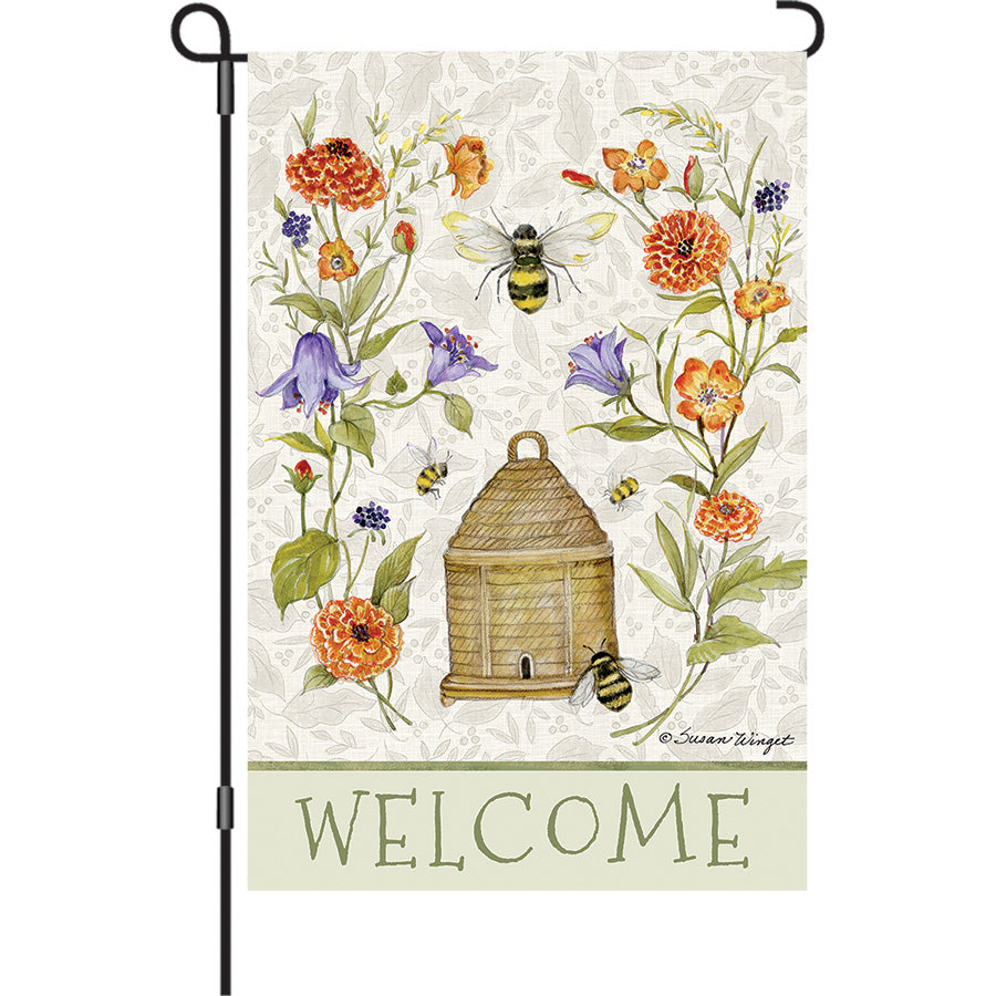 13 in. Elite Oversized Garden Flag featuring a colorful bee skep and flowers, displaying its vibrant theme in an outdoor setting.