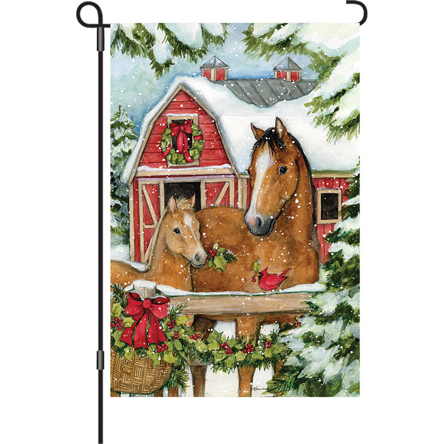 Festive 13 in. Elite Oversized Garden Flag featuring a Christmas Horse Barn scene, displayed outdoors with a garden flag pole.
