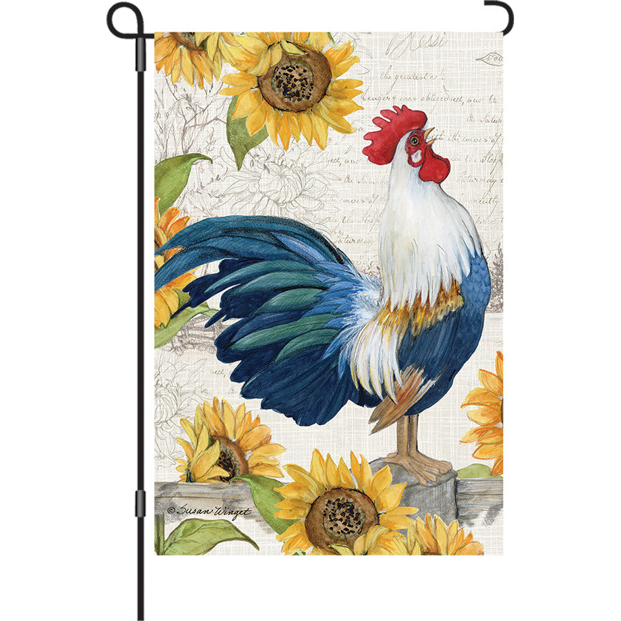 Vibrant 13 in. Elite Oversized Garden Flag featuring a rooster and sunflowers displayed on a garden pole in a sunny outdoor setting.