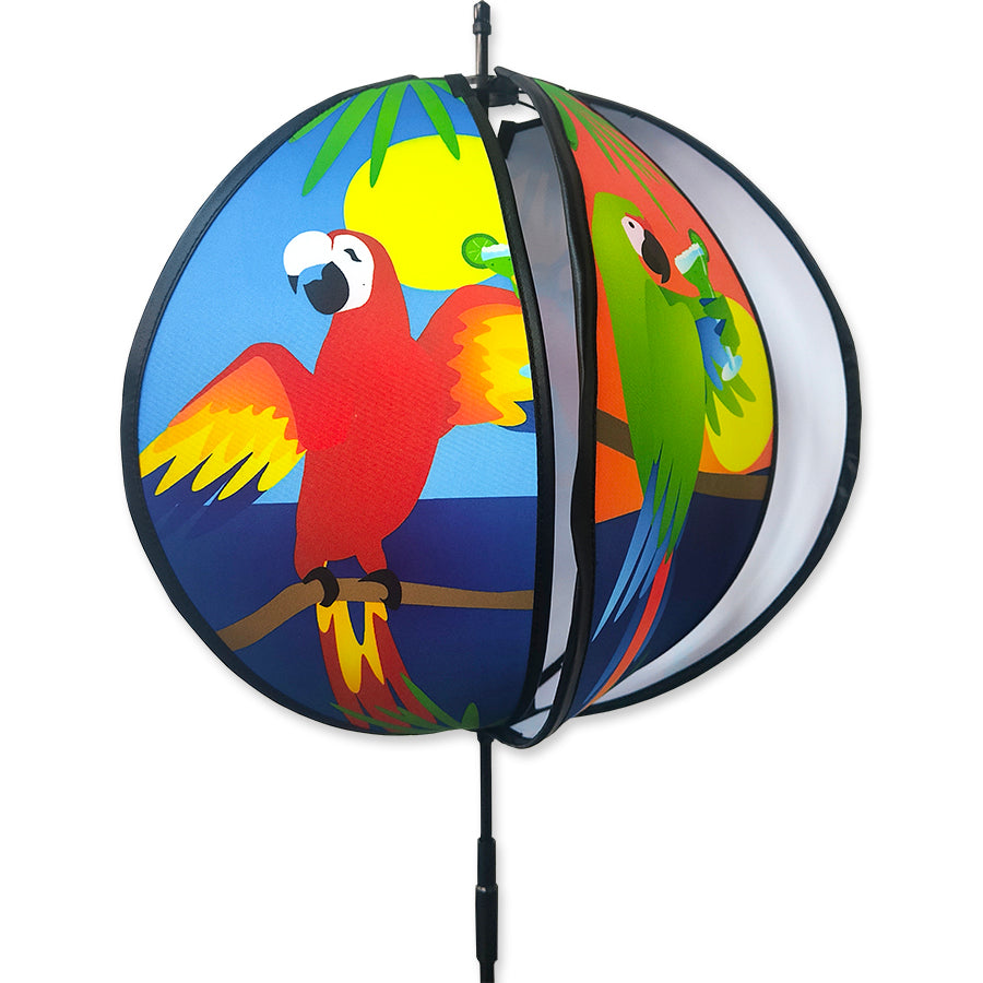15 in. Ball Spinner - 5 O'clock Somewhere features colorful panels with tropical drinks and birds, displayed in a garden setting.