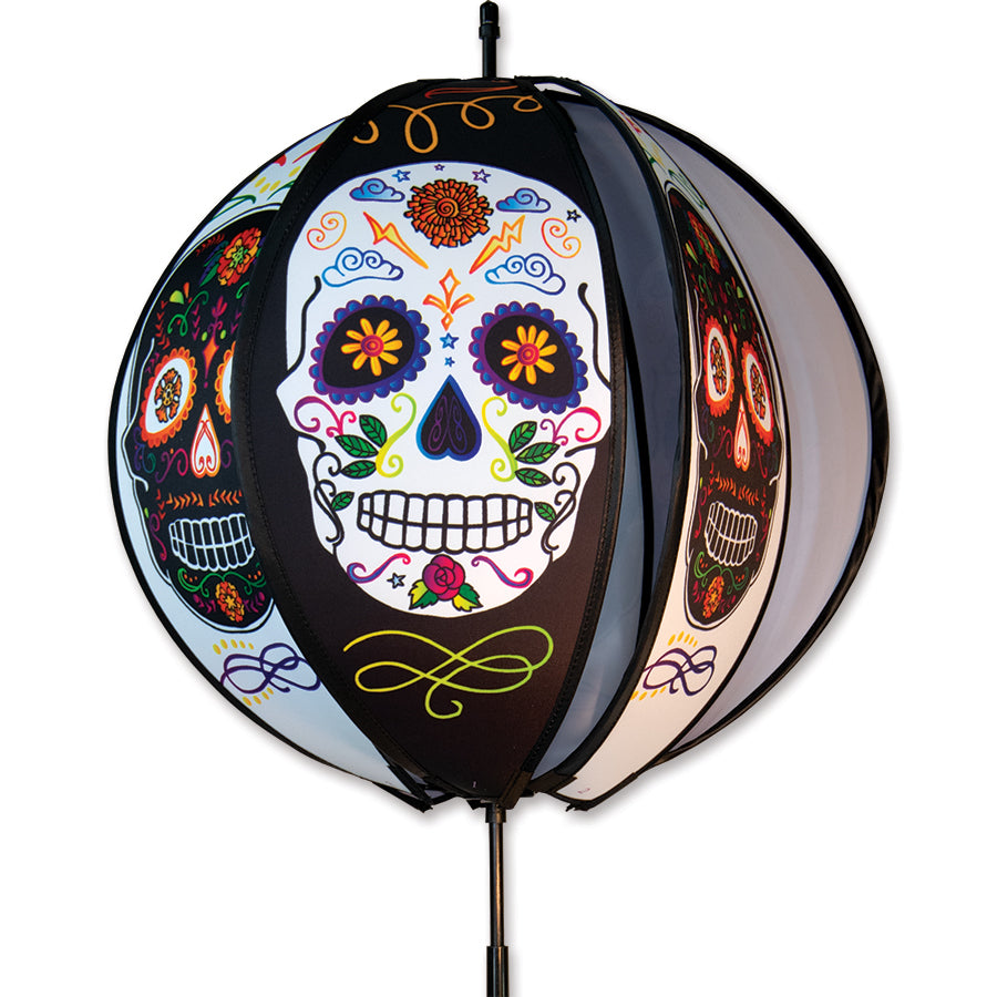 15 in. Ball Spinner - Day of the Dead featuring six colorful panels, displayed outdoors with vibrant colors twirling in the wind.