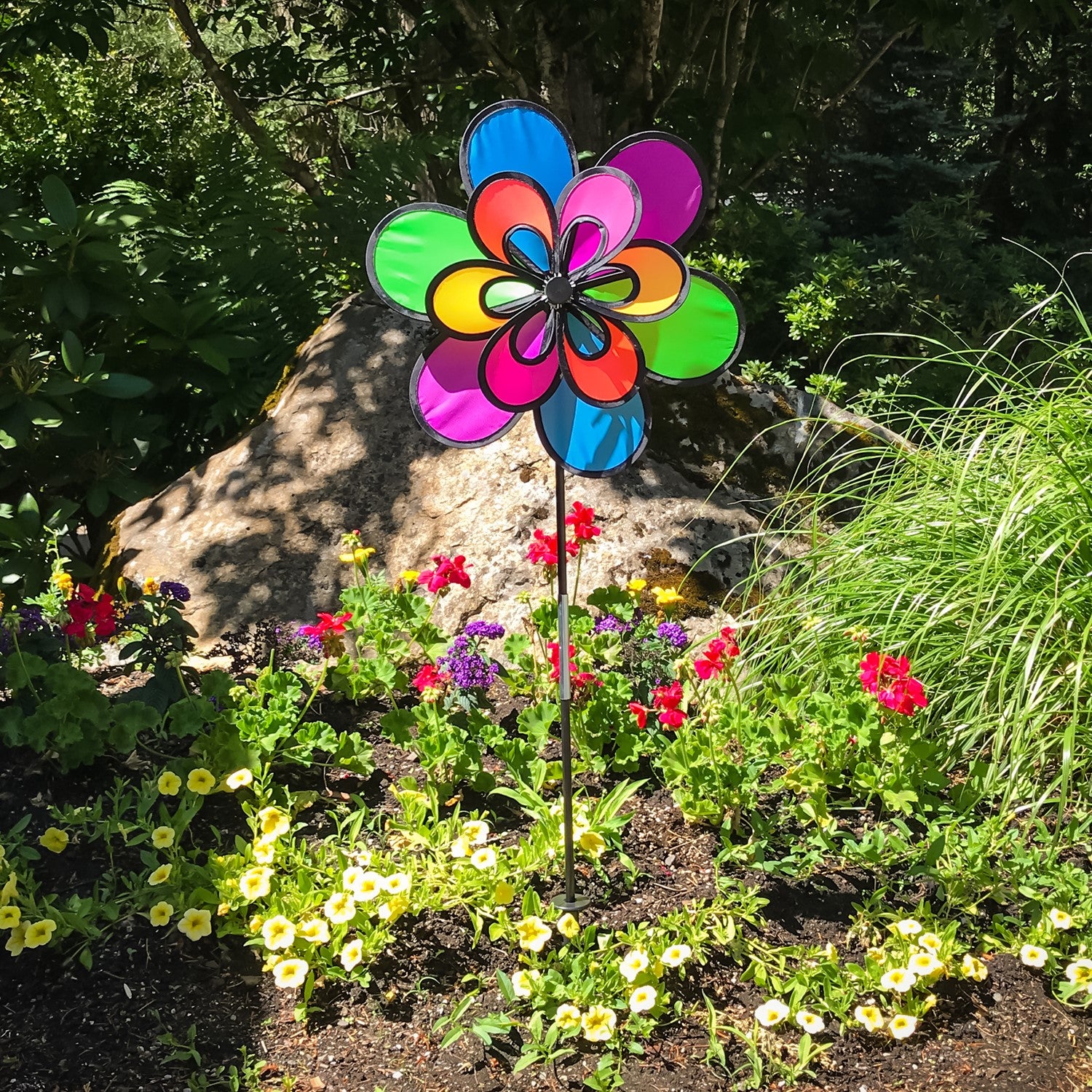 Brightly colored 15\" Neon Windee Wheelz and Flower Spinner in a garden setting, showcasing an animated flower design and spinning wheel.