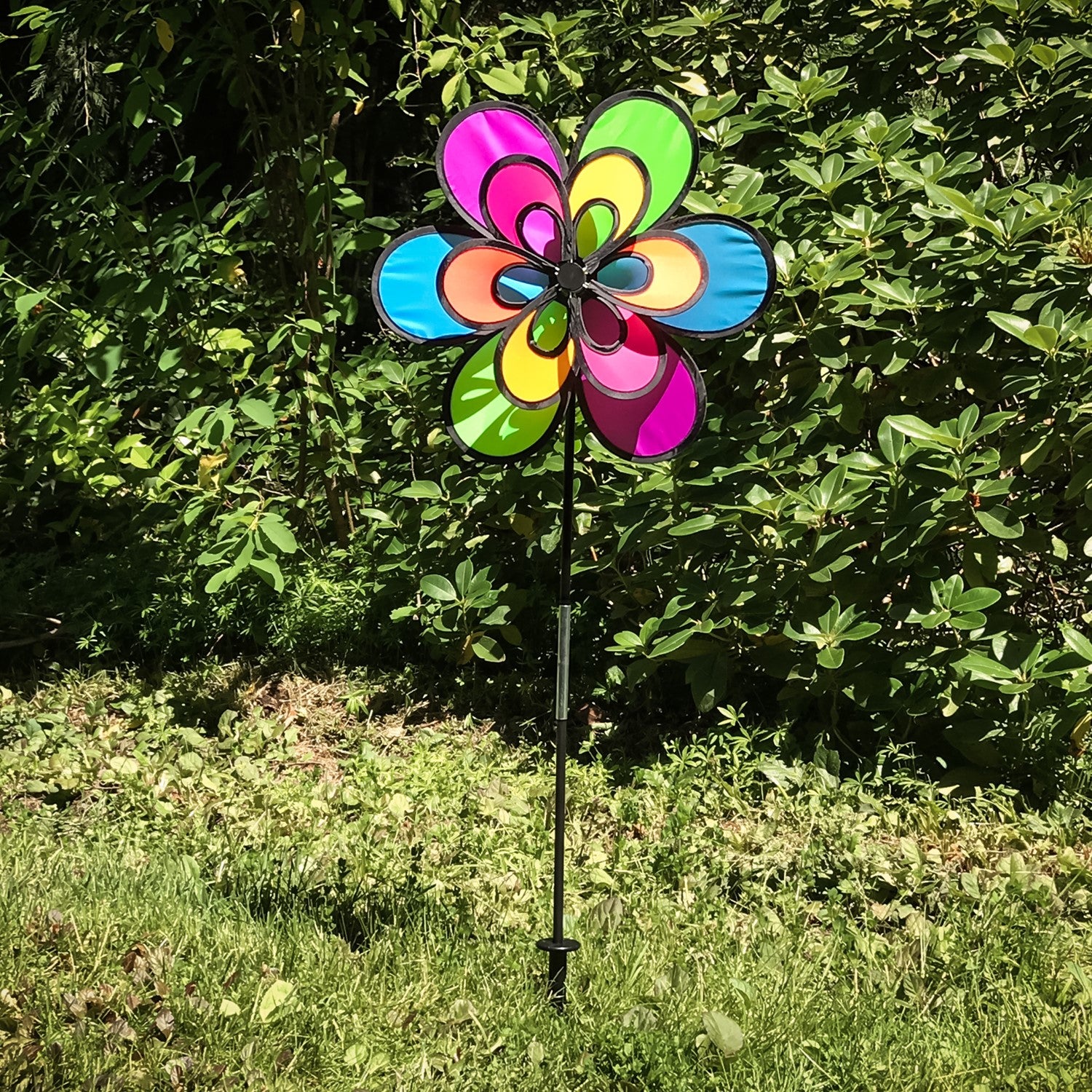 Brightly colored 15\" Neon Windee Wheelz and Flower Spinner in a garden setting, showcasing an animated flower design and spinning wheel.