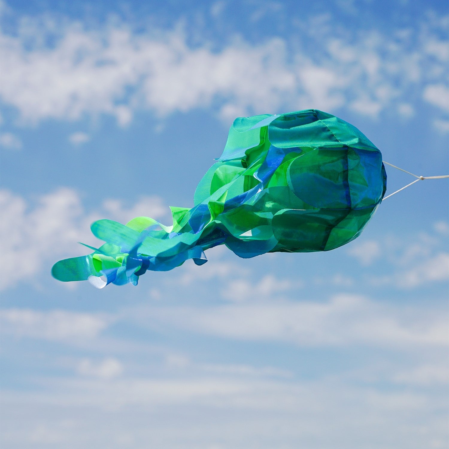 15-inch teal iridescent jellyfish 3D windsock with flowing tentacles and a shimmering finish, bringing ocean vibes to your yard while dancing in the wind.