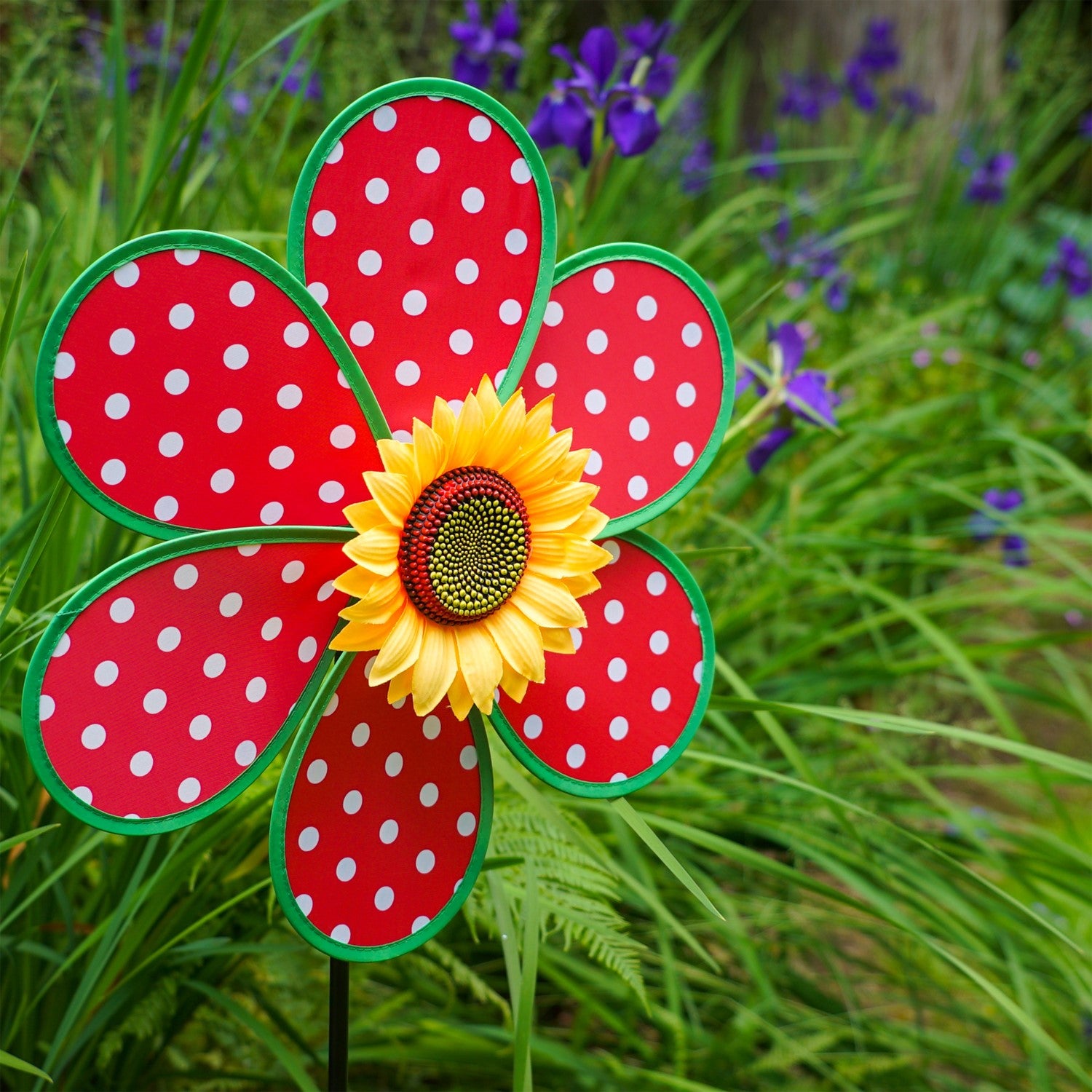 16" Polka Dot Flower with Leaves garden spinner featuring red and white polka dot petals and a sunflower center, displayed outdoors.