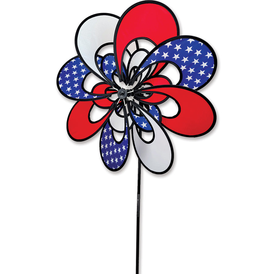 19 in. Double Whirly Spinner with colorful petals spinning in the breeze, displayed in a garden setting with vibrant flowers around it.