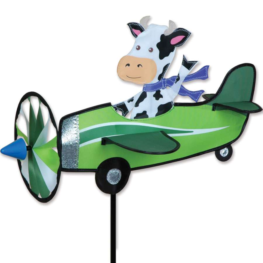 19 in. Pilot Pal Spinner - Cow displayed in a garden setting with vibrant colors and a playful spinning motion in the wind.