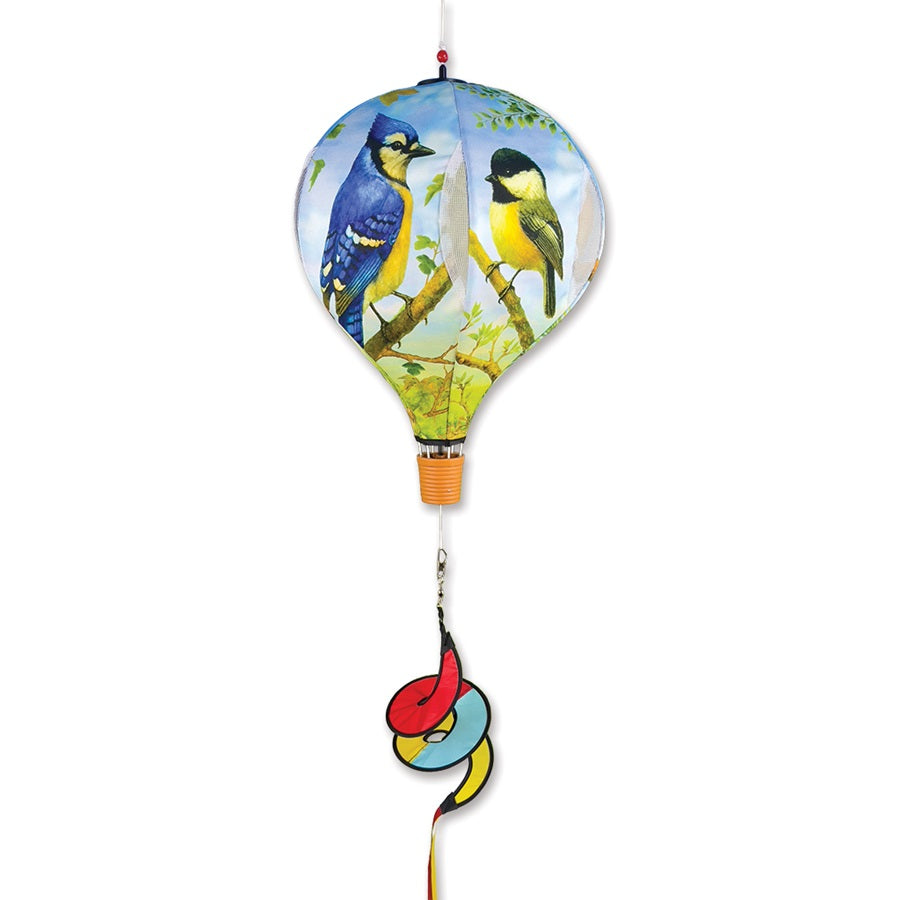19 in. Pop-Open Hot Air Balloon with Northeast Birds design, spinning gracefully in the wind above a deck or porch setting.