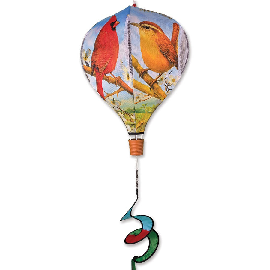 19 in. Pop-Open Hot Air Balloon featuring Southeast birds, brightly colored and spinning in the wind above a garden setting.