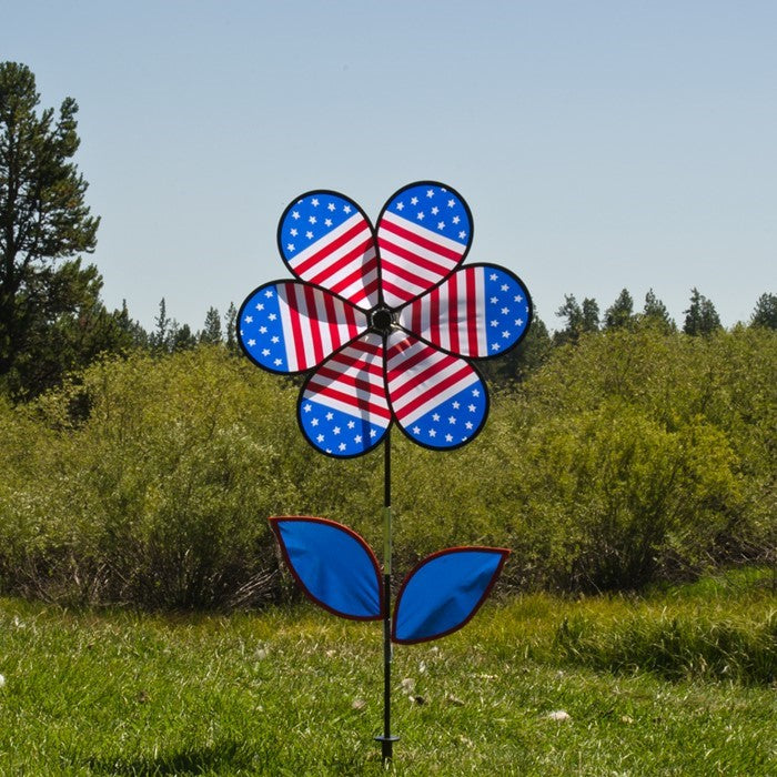 19-inch Patriotic Flower with Leaves spinning outdoors, showcasing bright stars and stripes petals attached to a sturdy fiberglass pole.