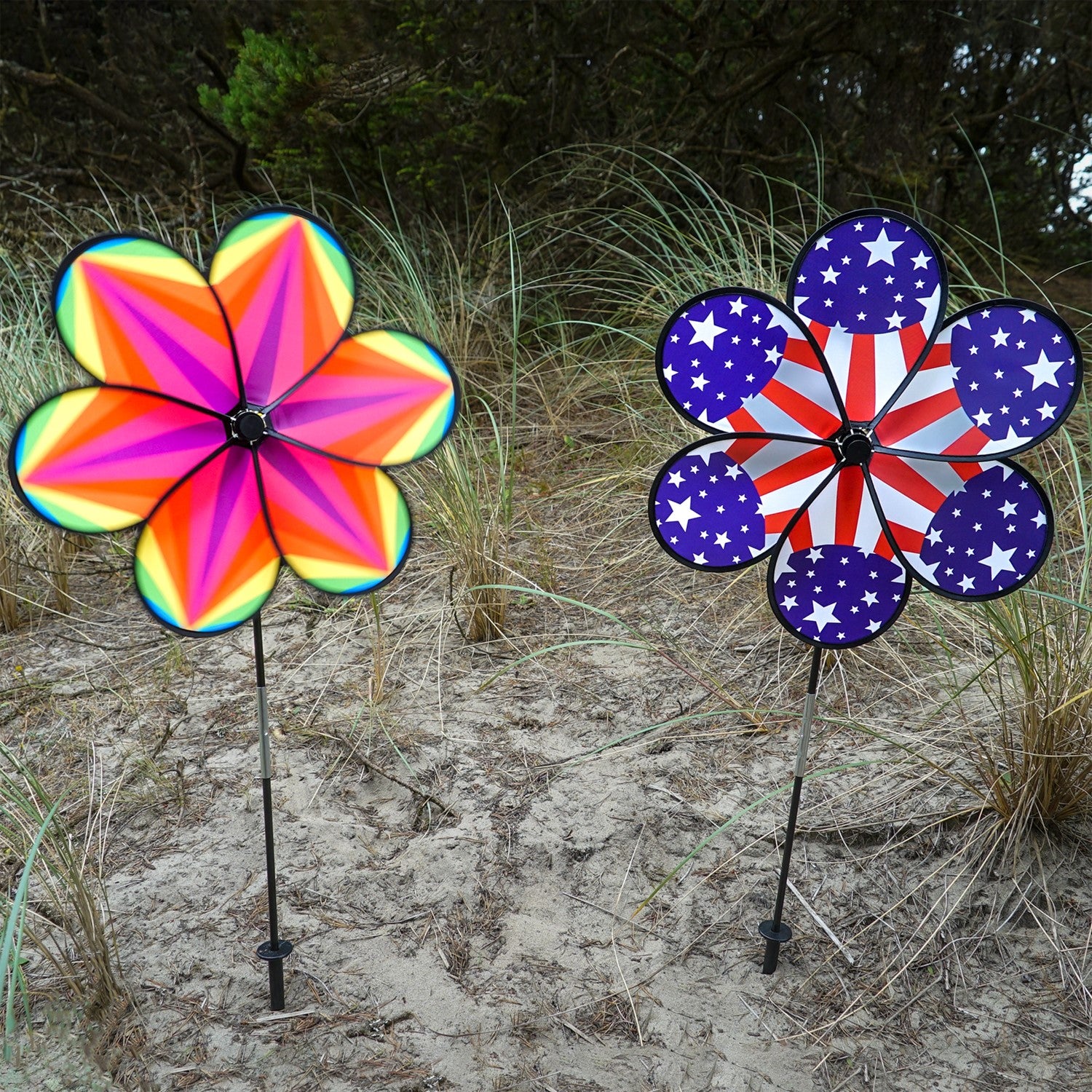 19-inch Rainbow Star Flower Spinner with colorful striped petals spinning in the breeze, displayed in a garden setting.