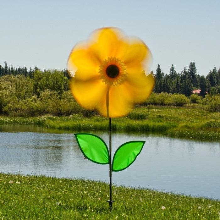 19-inch sunflower garden spinner with six bright yellow petals and two leaves on a fiberglass stem, elegantly rotating outdoors.