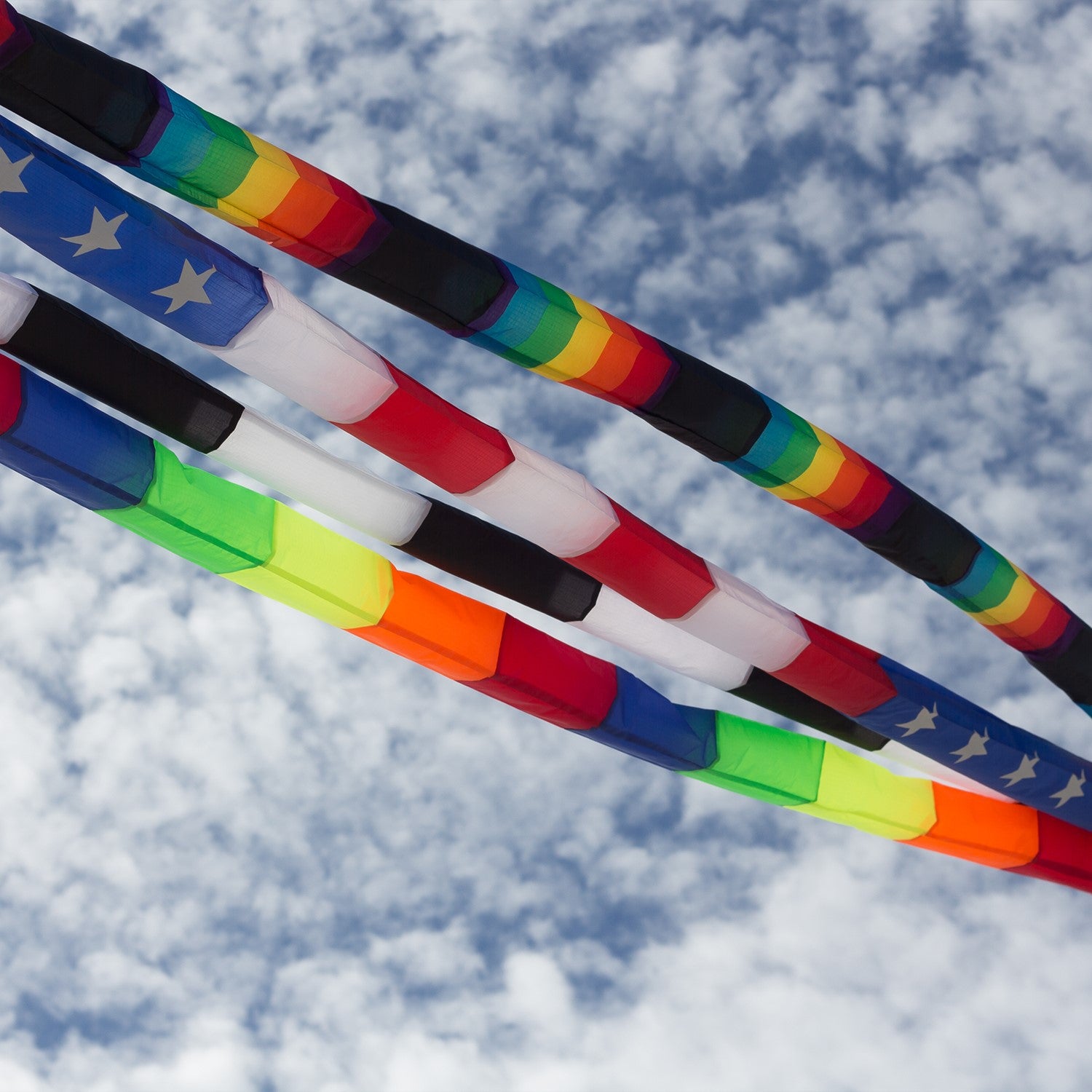 20-foot Patriotic Tube Tail featuring red, white, and blue stars and stripes, soaring high with an inflatable design attached to a kite.