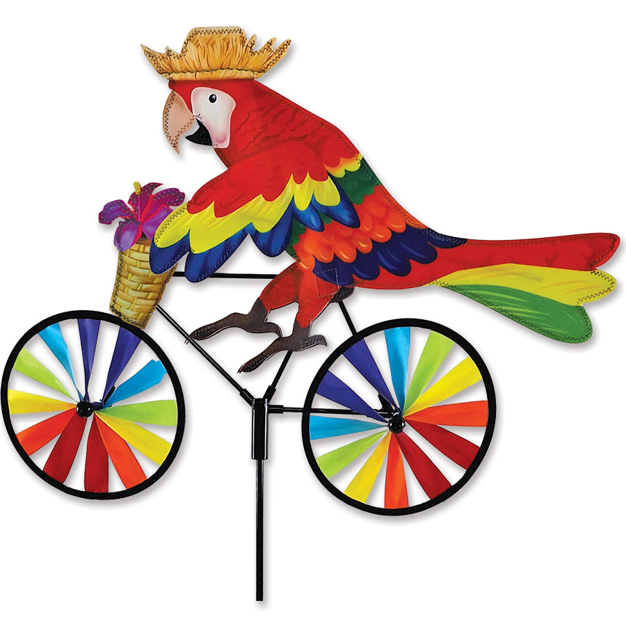 20 in. Bike Spinner with colorful parrot design spinning gracefully in the breeze in a garden setting.