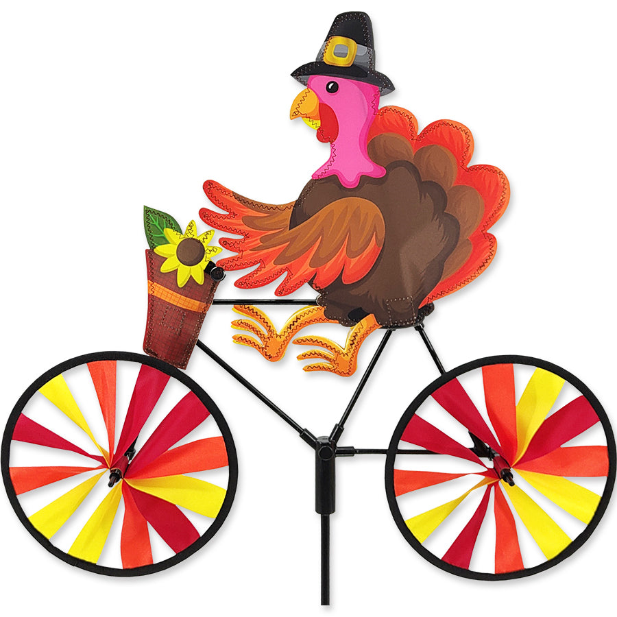 20 in. Bike Spinner featuring a colorful turkey design, spinning outdoors against a sunny backdrop in a vibrant garden setting.