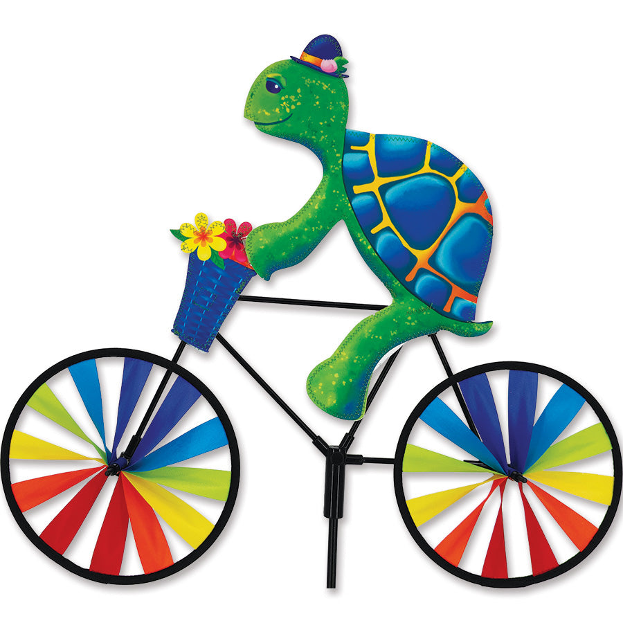 Colorful 20 in. Turtle Bike Spinner gently rotating in a garden setting, showcasing its vibrant design and sturdy construction.