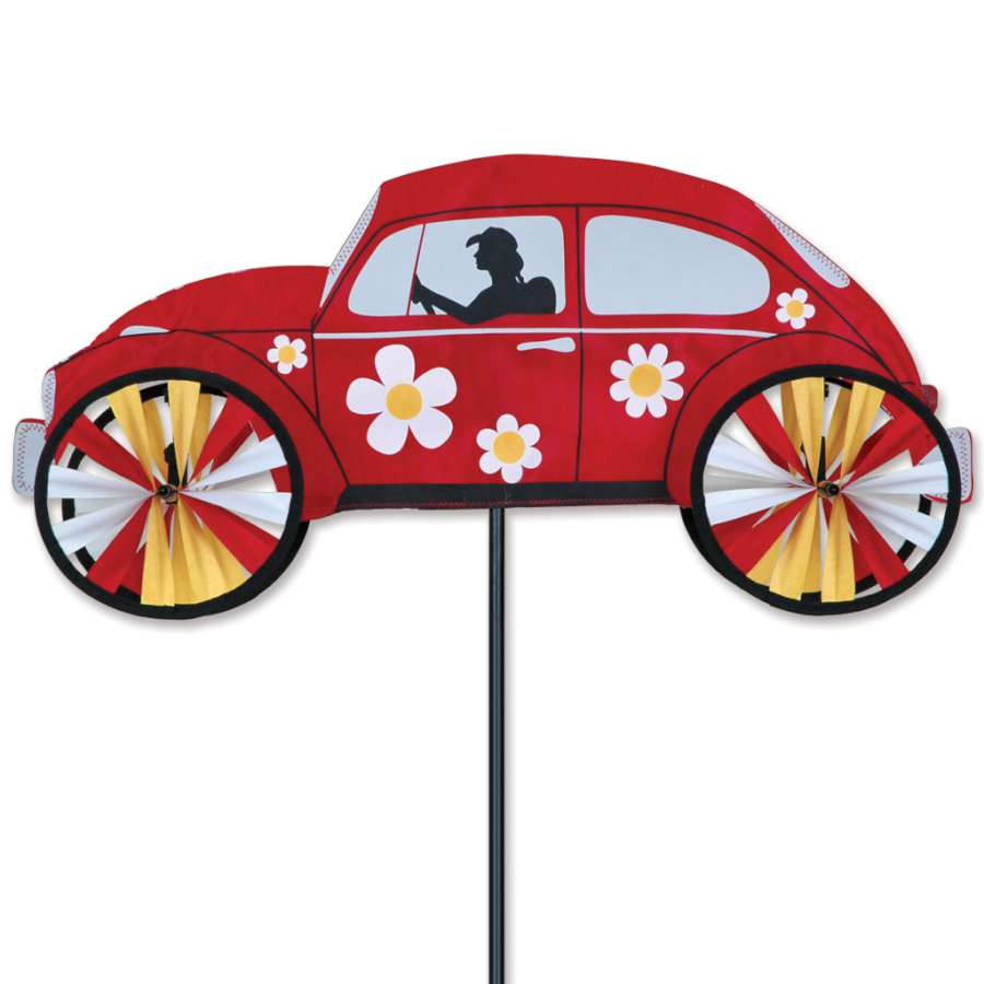 22 in. red Hippie Mobile Spinner, featuring a classic VW design, displayed in a garden with vibrant blossoms and greenery.