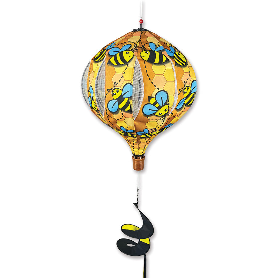 22 in. Pop-Open Hot Air Balloon with a cheerful bee design spinning under sunlight, displayed on a porch for vibrant outdoor decor.
