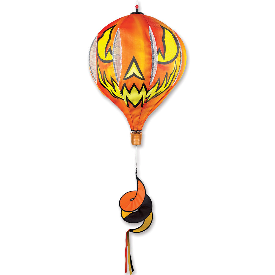22 in. Pop-Open Hot Air Balloon featuring a cheerful Jack O' Lantern design, spinning joyfully in the wind on a porch setting.