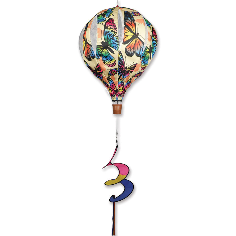 22 in. Pop-Open Hot Air Balloon featuring a vibrant neon butterflies design spinning joyfully in an outdoor setting, enhancing garden decor.