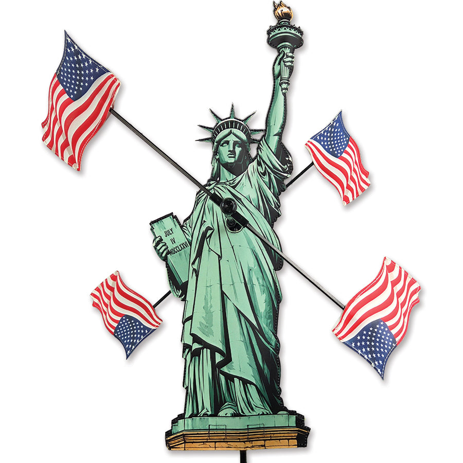 22 in. Lady Liberty WhirliGig Spinner features a swirling design with the U.S. flag, beautifully displayed in a garden setting.